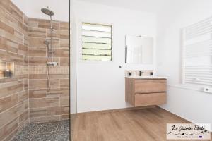 a bathroom with a shower and a sink at Meublé de tourisme " Le Jasmin Étoilé"- Hell-Bourg - SALAZIE in Salazie +23 photos