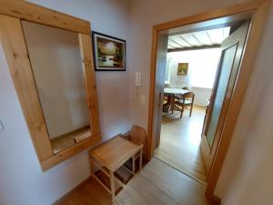 a room with a mirror and a chair and a table at Ferienwohnung Jäger in Viereth-Trunstadt