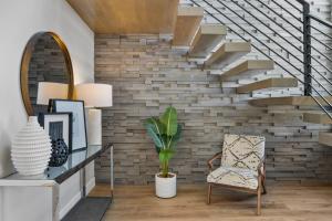 a living room with a staircase and a chair at Bunker on the 8th in Washington +53 photos