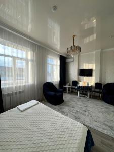 a bedroom with a bed and a living room at Гостиничный комплекс Paradise in Taldykorgan