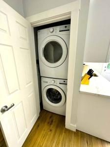 a washer and dryer in a small room at Cozy Walk up King Bed fast WiFi in Wilmington