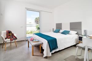 a bedroom with a bed and a large window at Evanthe Garden - Diantha in Lido Signorino