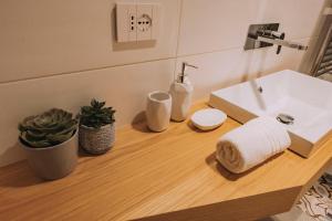 a bathroom with a sink and a towel on a counter at Sea Glow Luxury Apartment 2BR 2BA con vista mare a Bisceglie in Bisceglie