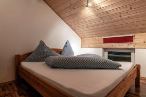 a bed with two pillows on it in a room at Haus Montanara myRelaxs in Tschagguns +43 photos