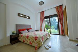 a bedroom with a bed and a large window at VILLA APPLE GARDEN RESORTS 45 MARRAKECH in Marrakesh +34 photos