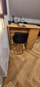 a desk with a chair and two glasses on it at Black Romance in Yville-sur-Seine