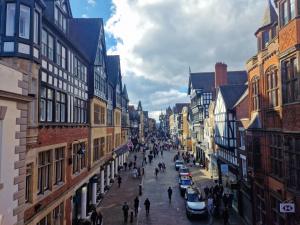 a group of people walking down a street with buildings at Stylish 3 bed home near central Chester - sleeps 6 in Chester