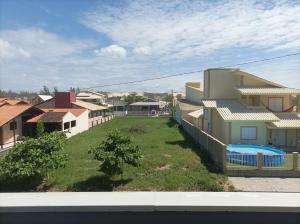 a view from the balcony of a house with a yard at AP Beira mar in Laranjal