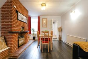 a dining room with a table and a brick wall at Unique 2BR House - Free Parking and Stunning Living Room in Nottingham