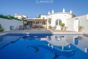 a swimming pool in front of a house at CASA LA MOTUCA - Calpe COSTA BLANCA in Calpe