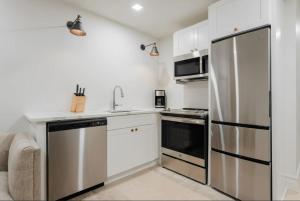 a kitchen with a stainless steel refrigerator at La Luz in San Antonio