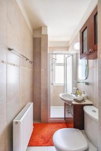 a bathroom with a toilet and a sink and a shower at Warm Residence in the heart of the City Center - Balcony & view in Nicosia