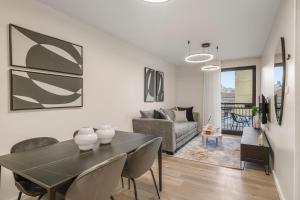 a living room with a table and a couch at Yashar Suites JLM in Jerusalem