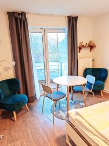 a room with chairs and a table and a window at Seeschloss 34 in Dahme
