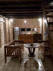 une cuisine avec une table et deux bancs ainsi qu'une cuisine avec un réfrigérateur dans l'établissement Amara Villa, à Gili Trawangan