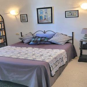 Un dormitorio con una cama grande con sábanas y almohadas púrpuras. en Djerba chambres d'hôtes en Houmt El Souk