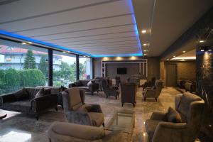 a waiting room with couches and chairs in a building at Dedeman Kemer Resort - Ultra All Inclusive in Kemer