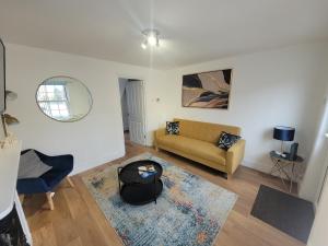 a living room with a couch and a mirror at Greenstead road - Cosy house in Town in Colchester