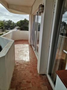 a walkway leading to a balcony with glass doors at apartamento Mirada I 22 ET-294PL in Es Pujols
