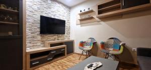 a living room with two chairs and a flat screen tv at DS Casa San Fernando in Córdoba