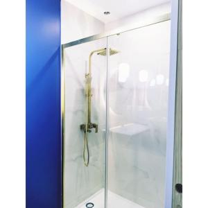 a shower with a glass door in a bathroom at Chalet côté montagne in Oz +29 photos