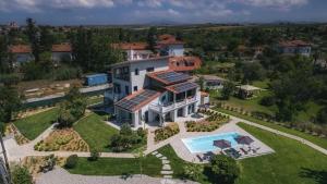 an aerial view of a house with a swimming pool at Electra BeachFront Suites, Nea Irakleia in Nea Iraklia