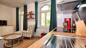 a kitchen with a counter and a table in a room at Georgentor in Naumburg +1 photo