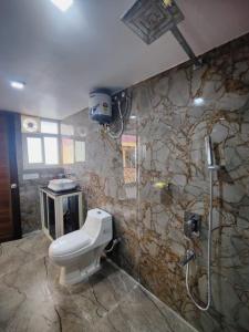 a bathroom with a toilet and a shower at Kalapani Seaview Service Apartment in Aberdeen