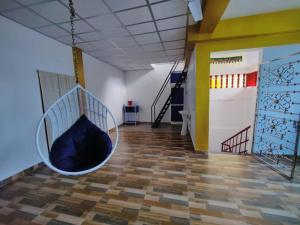 a room with a hanging hammock in the middle of a room at Kalapani Seaview Service Apartment in Aberdeen