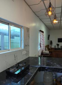 a kitchen with a black counter top and a window at Kalapani Seaview Service Apartment in Aberdeen