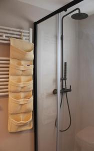 a towel rack in a bathroom with a shower at Casa Vittoria Martina Franca in Martina Franca