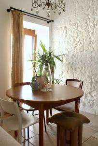 een eettafel en stoelen met een plant erop bij Casa Vittoria Martina Franca in Martina Franca