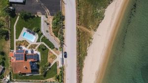 an aerial view of a house next to the beach at Electra BeachFront Suites, Nea Irakleia in Nea Iraklia