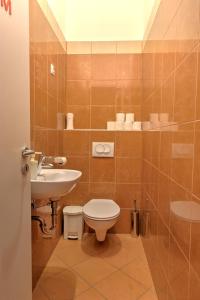 a bathroom with a toilet and a sink at Central Capital Apartments in Budapest