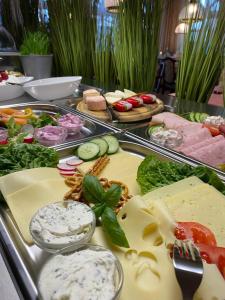 a buffet of food with cheese and other foods at Strandhotel Salty in Büsum