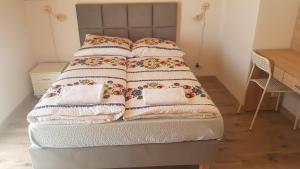 a bed with four pillows on top of it at Willa Maria in Łagów