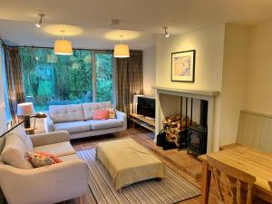 a living room with a couch and a fireplace at Finest Retreats - Ingleby Manor - Manor Cottage in Great Ayton