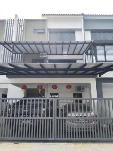 a building with a gate in front of it at Happy Chamang Guest House in Bentong