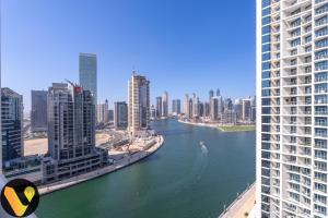 a view of a river in a city with buildings at Vogue Damac Prive near Burj Khalifa & Dubai Mall in Dubai