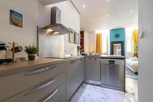 a kitchen with a sink and a dishwasher at Cosy Studio in the Old Town near Garibaldi Square in Nice