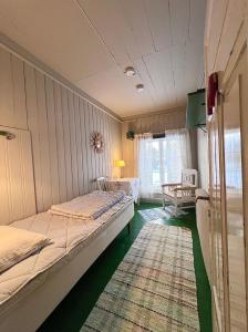 a bedroom with two beds and a rug at Norrsjön in Sörsjön