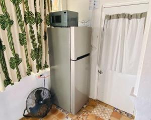 a small refrigerator with a microwave on top of it at Jaguar Studio in Tijuana