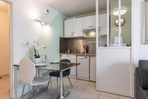 a kitchen with a table and chairs and a refrigerator at Quiet 1 bdr Port! close Place du Pin Garibaldi in Nice