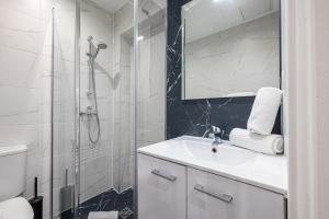 a white bathroom with a sink and a shower at Charming 1 Bdr Old town in Nice