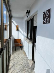 a hallway of a house with a chair and windows at Casa Vazan 