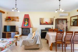 a living room with a couch and a fireplace at Villa Poros in Kavalloúrion