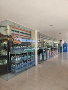 an empty aisle of a grocery store with bottles of water at 2-Bedroom Boutique City Condo - Newly Renovated! in Cebu City