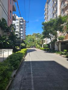 an empty street in a city with tall buildings at 2-Bedroom Boutique City Condo - Newly Renovated! in Cebu City