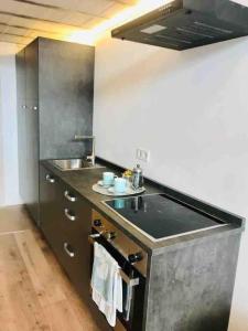 a kitchen with a sink and a counter top at 70m2 Loft with Patio only 20mn from Plaza Castilla C2 in Madrid