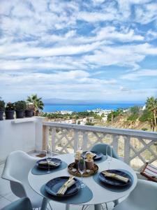 a table on a balcony with a view of the ocean at Sunshine Escape with ocean view in Adeje